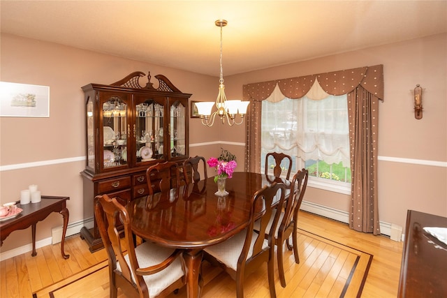25 Briarwood Dr, Wappingers Falls, NY 12590 - dining space with a chandelier, light wood-style flooring, and a baseboard heating unit