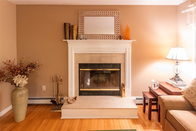 25 Briarwood Dr, Wappingers Falls, NY 12590 - detailed view of a tiled fireplace, wood finished floors, and a baseboard heating unit