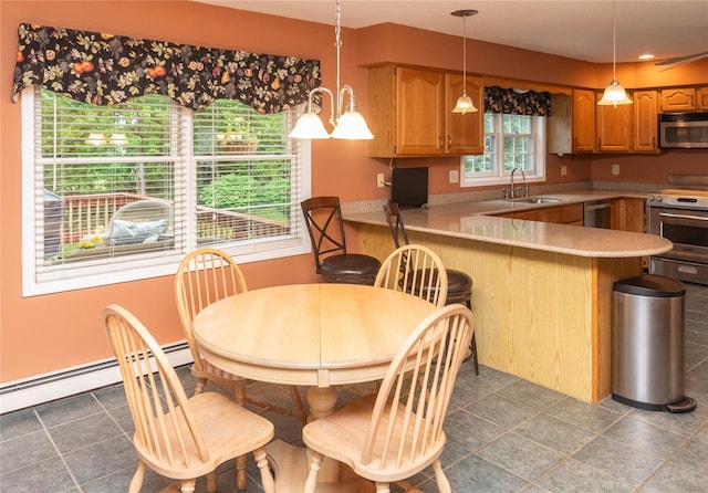25 Briarwood Dr, Wappingers Falls, NY 12590 - kitchen featuring a peninsula, stainless steel appliances, baseboard heating, decorative light fixtures, and light countertops