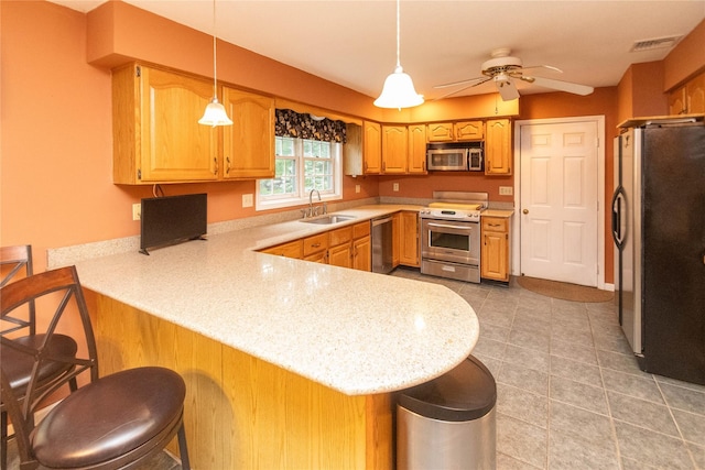 25 Briarwood Dr, Wappingers Falls, NY 12590 - kitchen with a peninsula, appliances with stainless steel finishes, light countertops, and ceiling fan