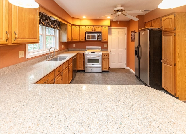 25 Briarwood Dr, Wappingers Falls, NY 12590 - kitchen featuring appliances with stainless steel finishes, ceiling fan, recessed lighting, light stone countertops, and brown cabinetry