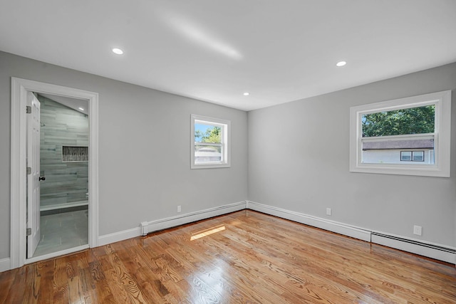 14 Sycamore St, Centereach, NY 11720 - unfurnished room featuring wood finished floors, recessed lighting, and baseboard heating
