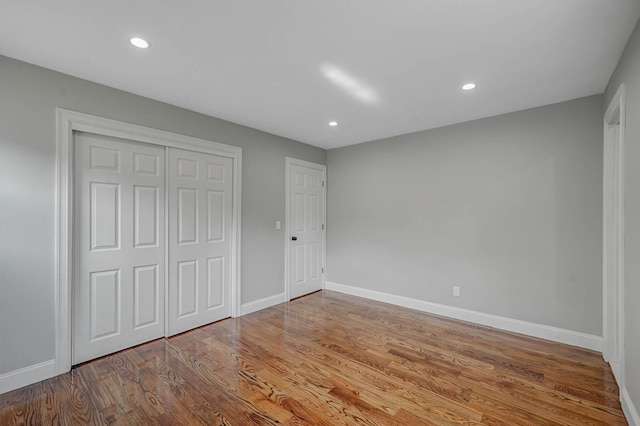 14 Sycamore St, Centereach, NY 11720 - unfurnished bedroom with wood finished floors, recessed lighting, and a closet