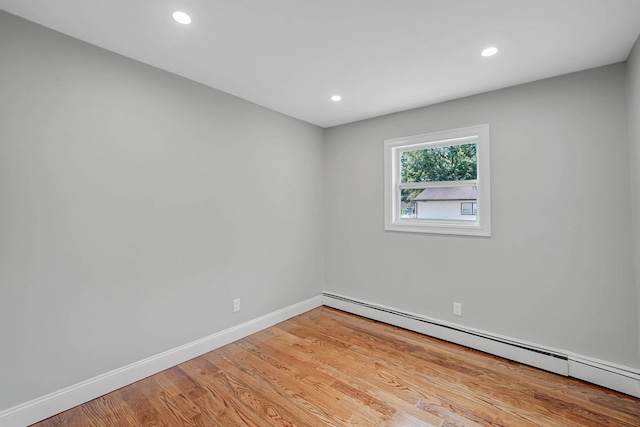 14 Sycamore St, Centereach, NY 11720 - spare room with a baseboard heating unit, light wood-style flooring, and recessed lighting