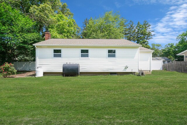 14 Sycamore St, Centereach, NY 11720 - rear view of property with heating fuel, a chimney, and a shingled roof