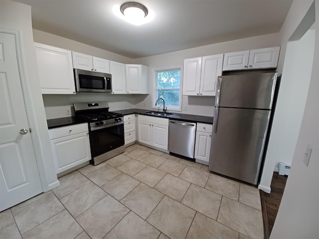 14 Laddie Rd, Middletown, NY 10941 - kitchen with appliances with stainless steel finishes, dark countertops, a baseboard heating unit, and white cabinetry