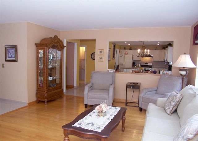 8 Long House Way, Commack, NY 11725 - living area featuring light wood-style flooring and a chandelier