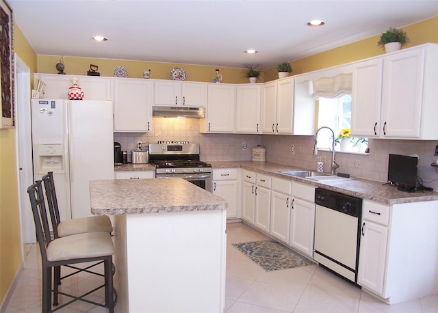 8 Long House Way, Commack, NY 11725 - kitchen with white appliances, under cabinet range hood, a kitchen island, white cabinets, and recessed lighting