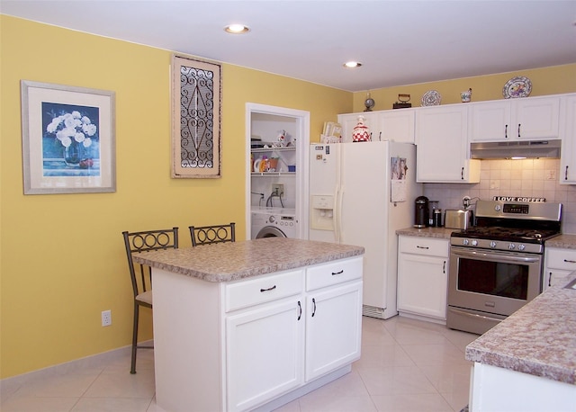 8 Long House Way, Commack, NY 11725 - kitchen with stainless steel range with gas cooktop, white fridge with ice dispenser, under cabinet range hood, washer / clothes dryer, and backsplash