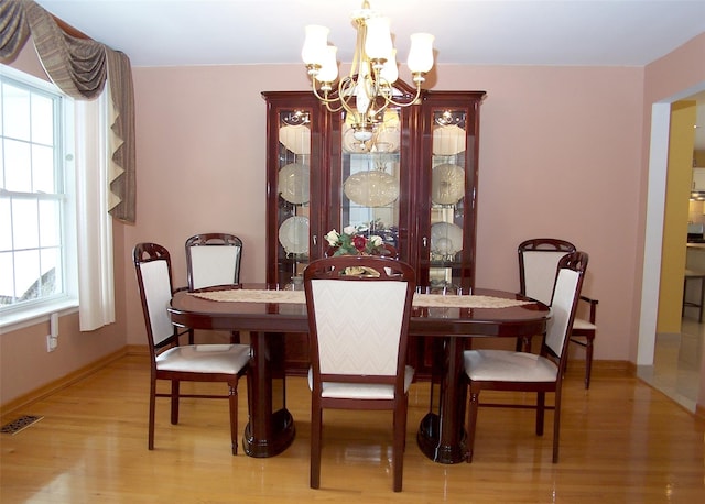 8 Long House Way, Commack, NY 11725 - dining area featuring a chandelier and light wood-style flooring
