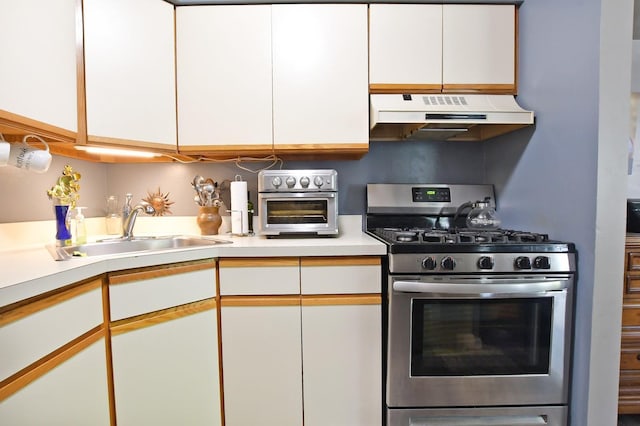310 Fairview Cir, Middle Island, NY 11953 - kitchen featuring gas stove, under cabinet range hood, white cabinetry, and light countertops