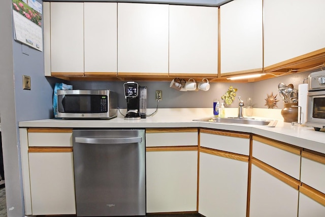 310 Fairview Cir, Middle Island, NY 11953 - kitchen with appliances with stainless steel finishes, light countertops, and white cabinets
