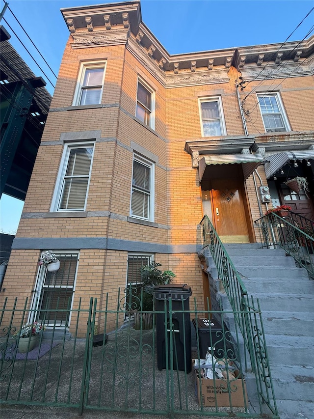 6616 60th St, Ridgewood, NY 11385 - view of building exterior with a fenced front yard