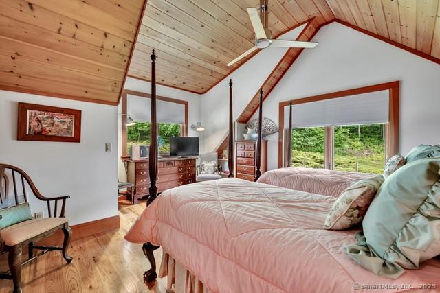 218 Kuhne Rd, Call Listing Agent, CT 06488 - bedroom featuring multiple windows, lofted ceiling, wood ceiling, wood finished floors, and access to exterior