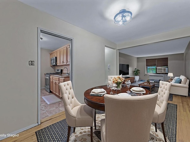 87-50 204th St Unit B46, Hollis, NY 11423 - dining room with light wood finished floors and baseboards