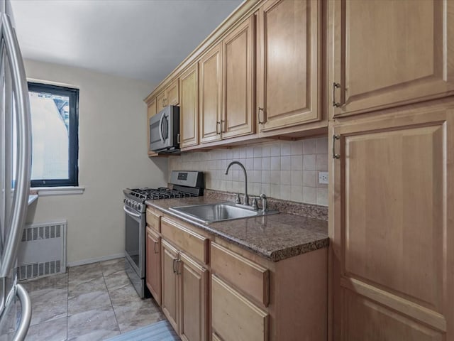 87-50 204th St Unit B46, Hollis, NY 11423 - kitchen featuring appliances with stainless steel finishes, dark countertops, radiator heating unit, decorative backsplash, and light marble finish floors
