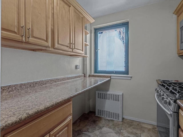 87-50 204th St Unit B46, Hollis, NY 11423 - kitchen with radiator heating unit, stainless steel range with gas stovetop, and light brown cabinetry