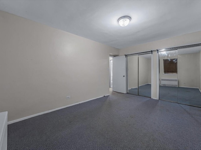 87-50 204th St Unit B46, Hollis, NY 11423 - unfurnished bedroom featuring multiple closets, radiator heating unit, and carpet floors
