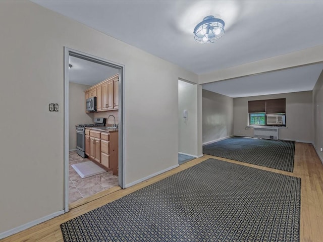 87-50 204th St Unit B46, Hollis, NY 11423 - hallway featuring light wood-type flooring, radiator, and cooling unit