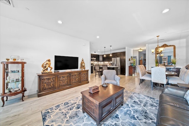 105 Captain S Way, Copiague, NY 11726 - living area featuring recessed lighting, a chandelier, and light wood-type flooring