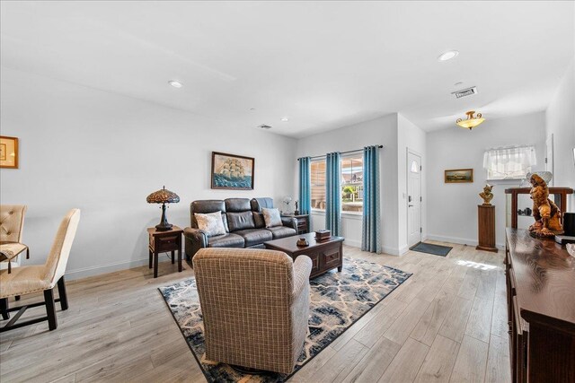 105 Captain S Way, Copiague, NY 11726 - living room featuring light wood-type flooring and recessed lighting