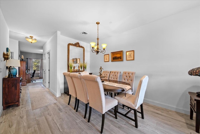 105 Captain S Way, Copiague, NY 11726 - dining space featuring a chandelier and light wood-style floors