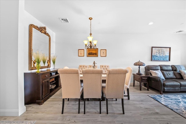 105 Captain S Way, Copiague, NY 11726 - dining area with a chandelier, light wood finished floors, and recessed lighting