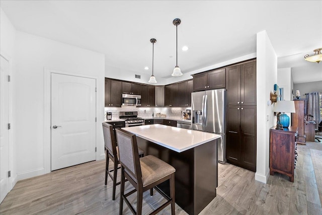 105 Captain S Way, Copiague, NY 11726 - kitchen featuring appliances with stainless steel finishes, light wood-type flooring, dark brown cabinetry, and recessed lighting