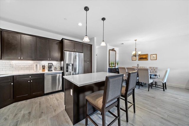 105 Captain S Way, Copiague, NY 11726 - kitchen with appliances with stainless steel finishes, light wood-style floors, and dark brown cabinets