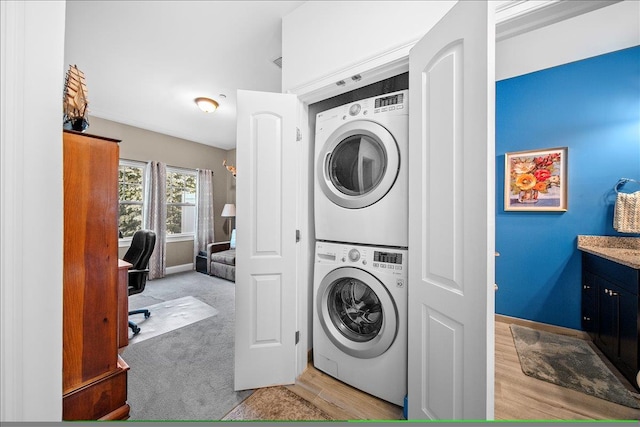 105 Captain S Way, Copiague, NY 11726 - washroom with stacked washer / dryer, light wood finished floors, and a desk