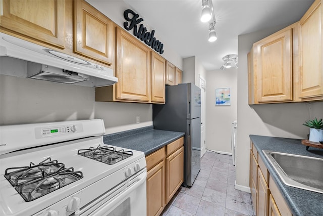 276 Temple Hill Rd Unit 1611, Vails Gate, NY 12553 - kitchen featuring white gas stove, light marble finish flooring, under cabinet range hood, freestanding refrigerator, and dark countertops