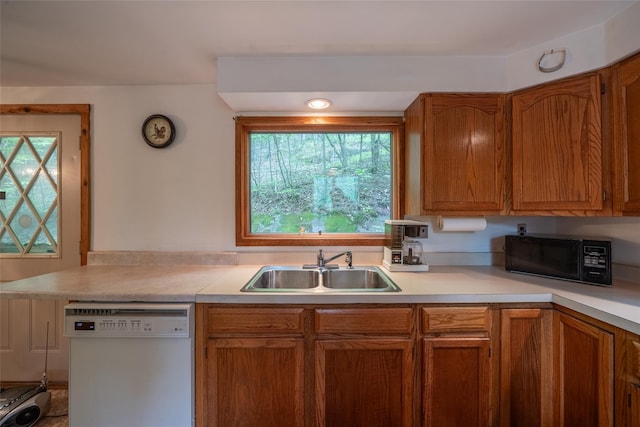 442 Main St, Grahamsville, NY 12740 - kitchen featuring white dishwasher, black microwave, light countertops, and brown cabinets