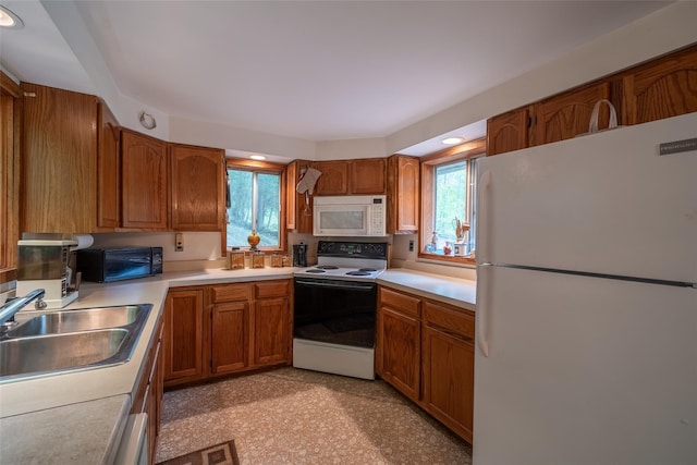 442 Main St, Grahamsville, NY 12740 - kitchen with white appliances, brown cabinetry, and light countertops