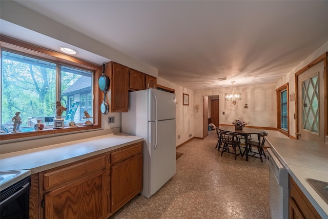 442 Main St, Grahamsville, NY 12740 - kitchen featuring white appliances, a chandelier, brown cabinets, and light countertops