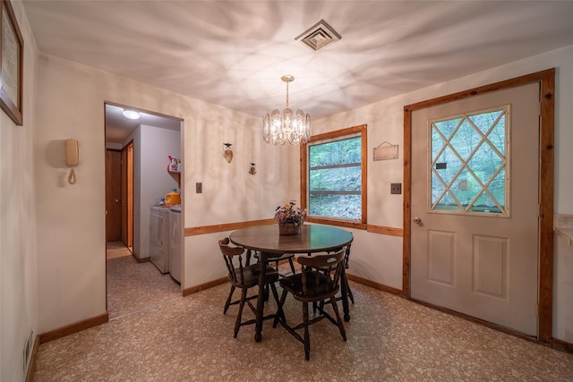 442 Main St, Grahamsville, NY 12740 - dining room with separate washer and dryer and a chandelier