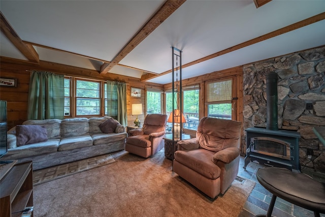 442 Main St, Grahamsville, NY 12740 - carpeted living room with a wood stove, healthy amount of natural light, wooden walls, and beam ceiling