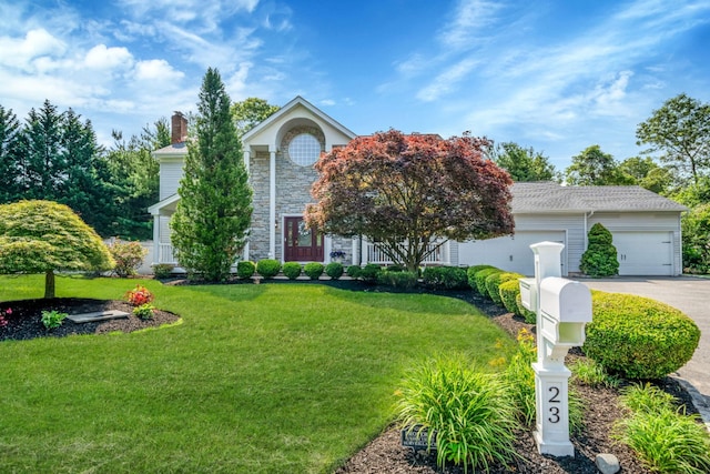 23 Antona Blvd, Centereach, NY 11720 - view of front of house featuring concrete driveway, a chimney, a front lawn, and a garage
