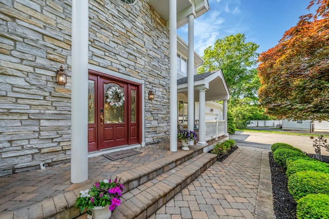 23 Antona Blvd, Centereach, NY 11720 - doorway to property featuring stone siding and a porch