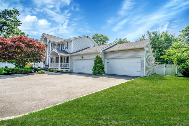 23 Antona Blvd, Centereach, NY 11720 - traditional-style home with driveway, a garage, a porch, and roof with shingles