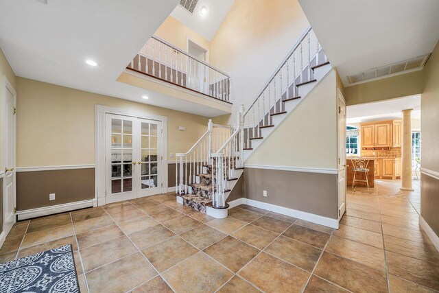 23 Antona Blvd, Centereach, NY 11720 - stairway with french doors, tile patterned flooring, ornate columns, recessed lighting, and a high ceiling