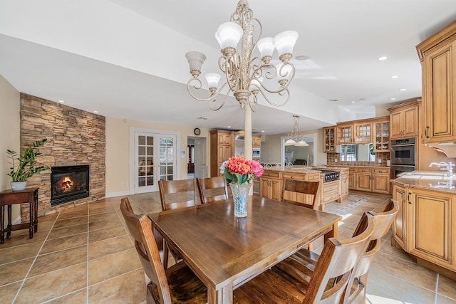 23 Antona Blvd, Centereach, NY 11720 - dining area featuring a chandelier, a fireplace, recessed lighting, and light tile patterned floors