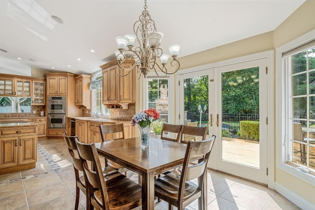 23 Antona Blvd, Centereach, NY 11720 - dining space featuring a chandelier, light tile patterned floors, recessed lighting, and lofted ceiling