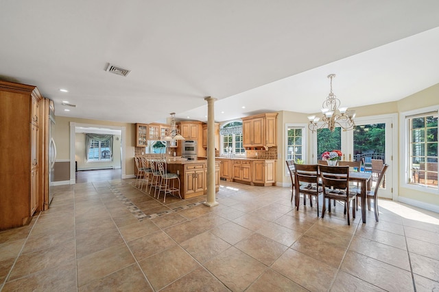 23 Antona Blvd, Centereach, NY 11720 - dining area with recessed lighting, a chandelier, ornate columns, and light tile patterned floors