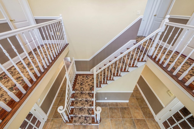 23 Antona Blvd, Centereach, NY 11720 - staircase with tile patterned flooring and a towering ceiling