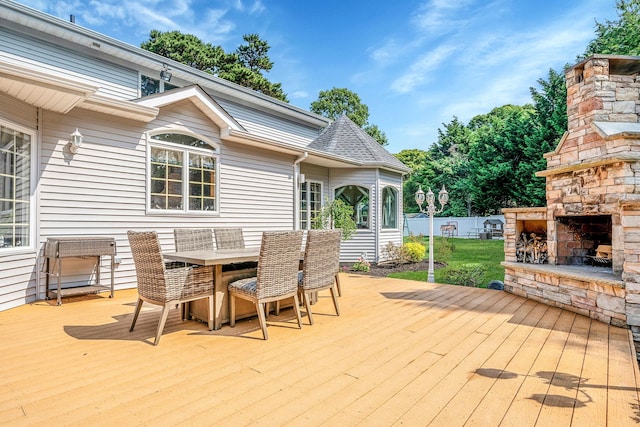 23 Antona Blvd, Centereach, NY 11720 - wooden deck with an outdoor stone fireplace and outdoor dining space