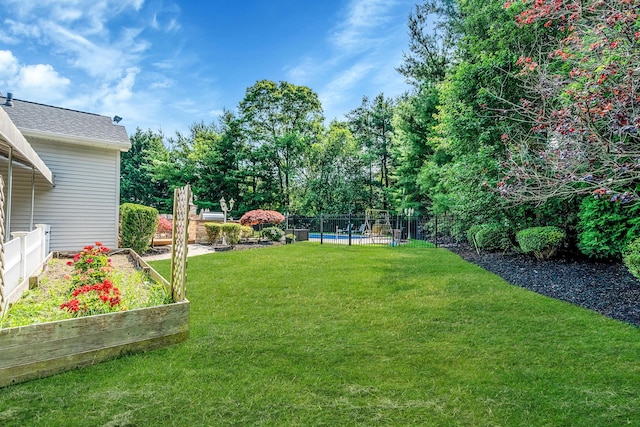 23 Antona Blvd, Centereach, NY 11720 - fenced yard featuring a swimming pool and a garden