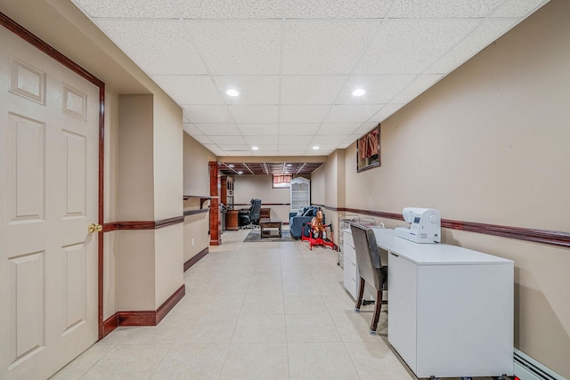 23 Antona Blvd, Centereach, NY 11720 - hallway featuring a drop ceiling, a desk, recessed lighting, a baseboard heating unit, and light tile patterned flooring