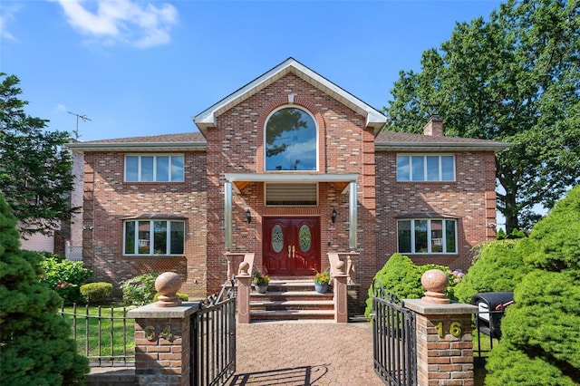 64-16 211th St, Bayside, NY 11364 - traditional-style home with a fenced front yard, brick siding, and a gate