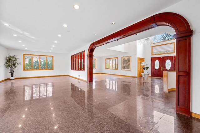 64-16 211th St, Bayside, NY 11364 - unfurnished room with granite floors, arched walkways, healthy amount of natural light, and recessed lighting