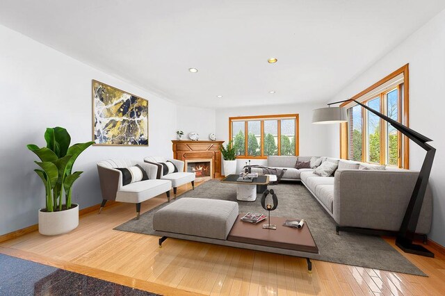 64-16 211th St, Bayside, NY 11364 - living area featuring wood-type flooring, a lit fireplace, and recessed lighting